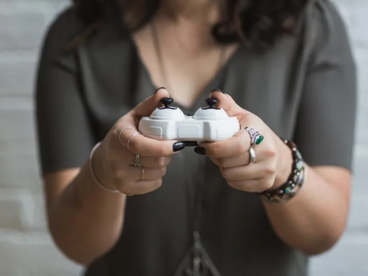 Person holding a white game controller
